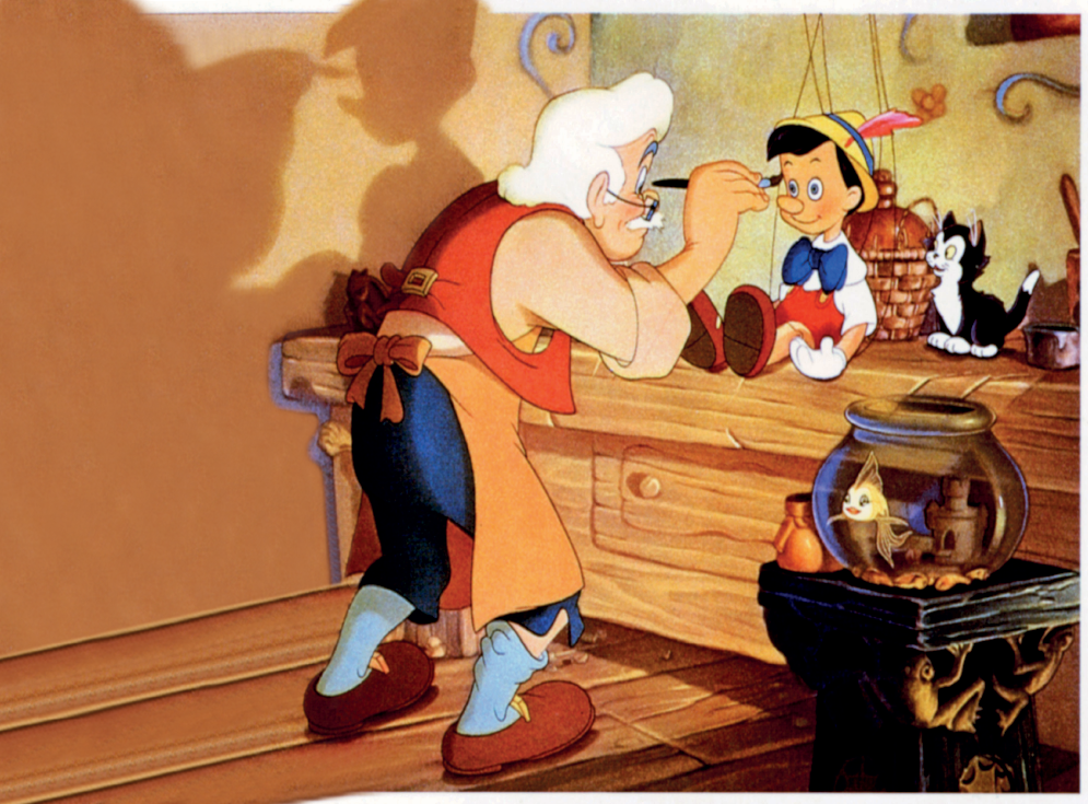 Imagem: Ilustração. Dentro de um local fechado com paredes e chão em marrom-claro, um senhor pintando um boneco sobre móvel de madeira marrom. O senhor tem pele clara, cabelos e bigode branco, usando blusa de mangas compridas em bege, colete vermelho por cima, usando calça de cor azul-escuro, meiões em azul-claro, com sapatos de cor marrom. Sobre ele, um avental de cor laranja, um par de óculos de grau no rosto. Ele está agachado para à direita, com um pincel na mão direita sobre o boneco Pinóquio. Este tem o corpo de madeira de cor bege, cabelos pretos penteados para à esquerda, com blusa de cor branca, gravata azul, bermuda e sapatos em vermelho, com chapéu de cor amarela com detalhe em azul e pena de cor vermelha, com um par de luvas de cor branca nas mãos. Sobre ele, cordões de fantoche amarrados em partes do corpo dele. Atrás, um cesto bege. À direita dele, um gato de pelos brancos, com a cabeça, dorso e rabo em preto e olhos amarelos. À frente, à direita, sobre uma pequena mesa, um aquário com peixe de cor amarela dentro e pequenas construções dentro do aquário. À esquerda, vaso pequeno de cor marrom-claro.  Fim da imagem.