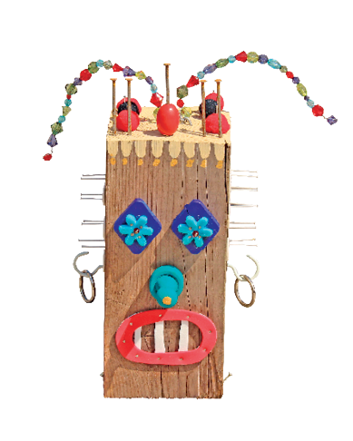 Imagem: Fotografia. Objeto com formato de haste de madeira na vertical de cor bege-claro, com o formato arredondado de cor azul-claro, com dois olhos em bege parte superior em marrom e várias hastes na vertical de cor preta e ponta superior em vermelho. No pescoço, pintura em azul-escuro com gravata.  Fim da imagem.