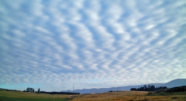 Imagem: Fotografia. Rastros de nuvens brancas no céu azul-claro.  Fim da imagem.