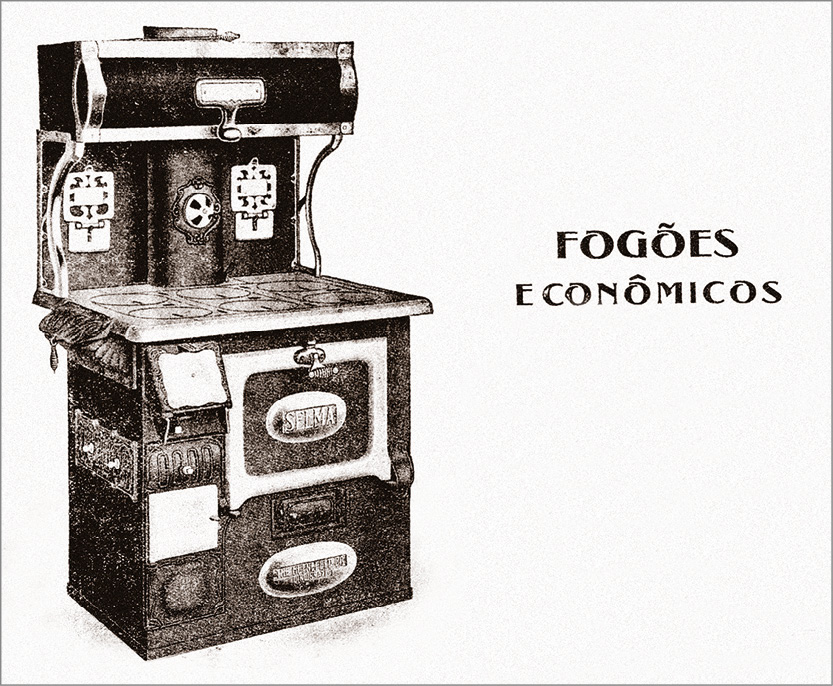 Imagem: Cartaz em preto e branco. Um fogão que apresenta design robusto, com forno de porta grossa, com seis bocas que não apresentam relevo e uma estrutura na parte superior que apresenta uma manivela. Ao lado do utensílio está escrito: “Fogões econômicos”.  Fim da imagem.